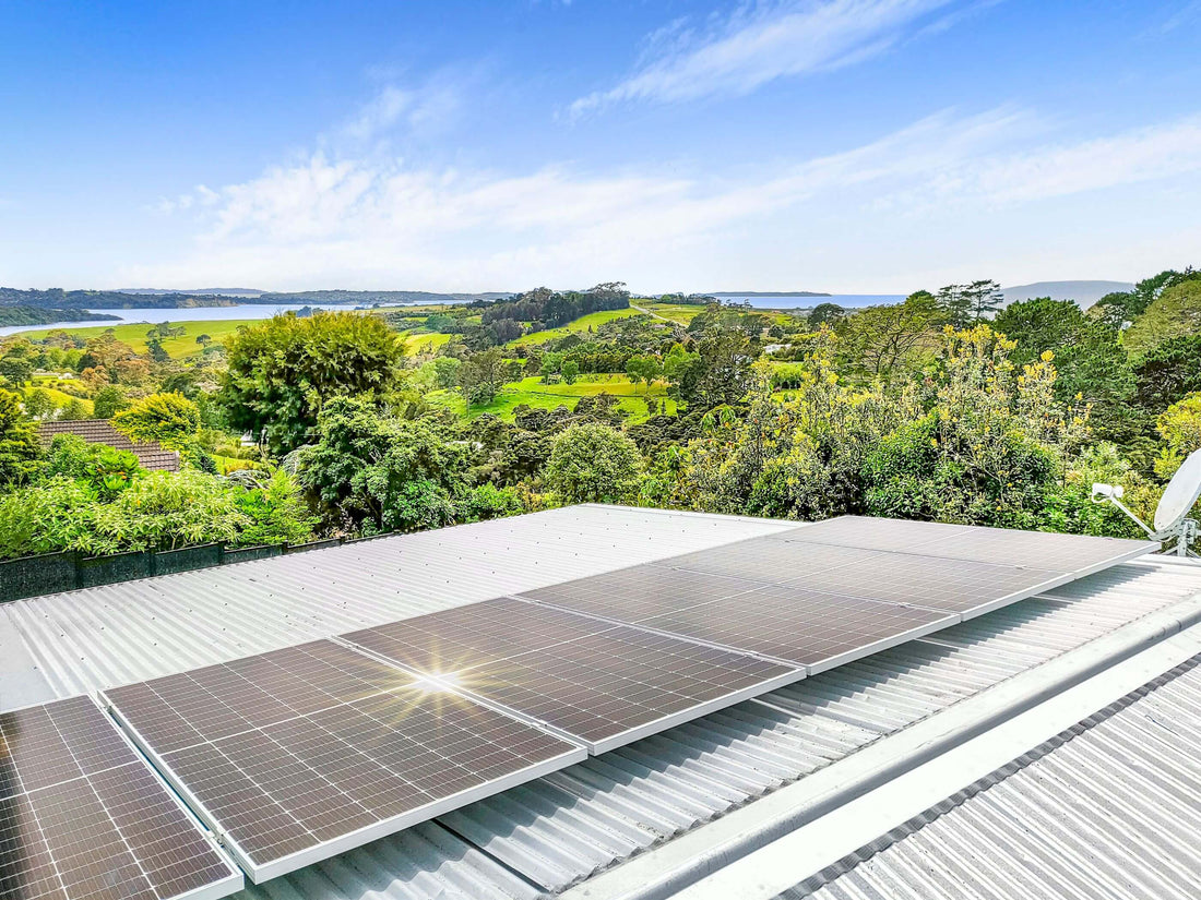 Six solar panels on a residential roof overlooking trees