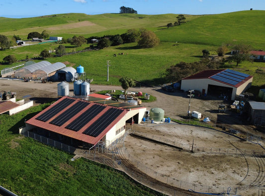 A farm with buildings with solar panels installed on its roof